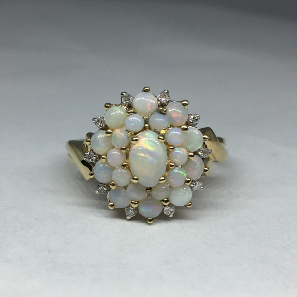 A 9 ct Gold Opal and 10 Diamond Oval Cluster Ring . - Talking Antiques